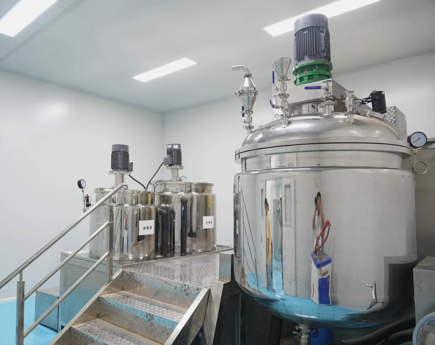 Stainless steel production tanks in an organized manufacturing area
